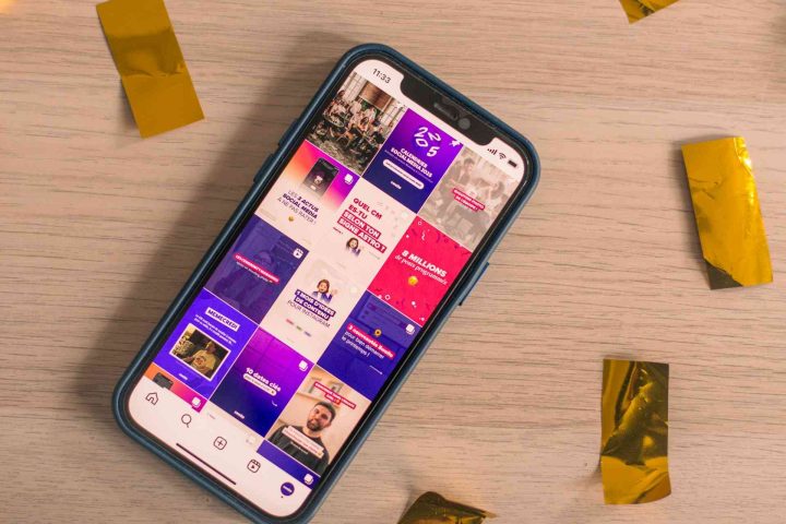 A smartphone displaying the Swello Instagram profile on a wooden surface surrounded by gold confetti