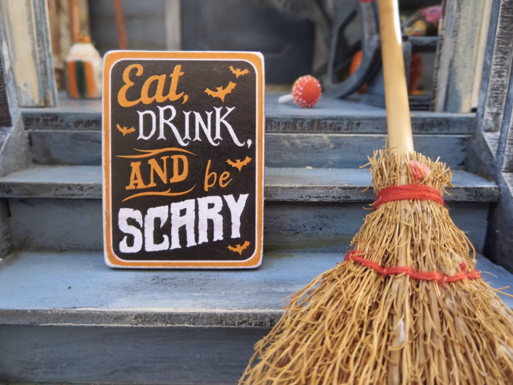photo-1571152013534-fdc8f268ce37 Halloween sign reading Eat, DRINK, AND be SCARY using a mix of script, serif, and distressed block fonts